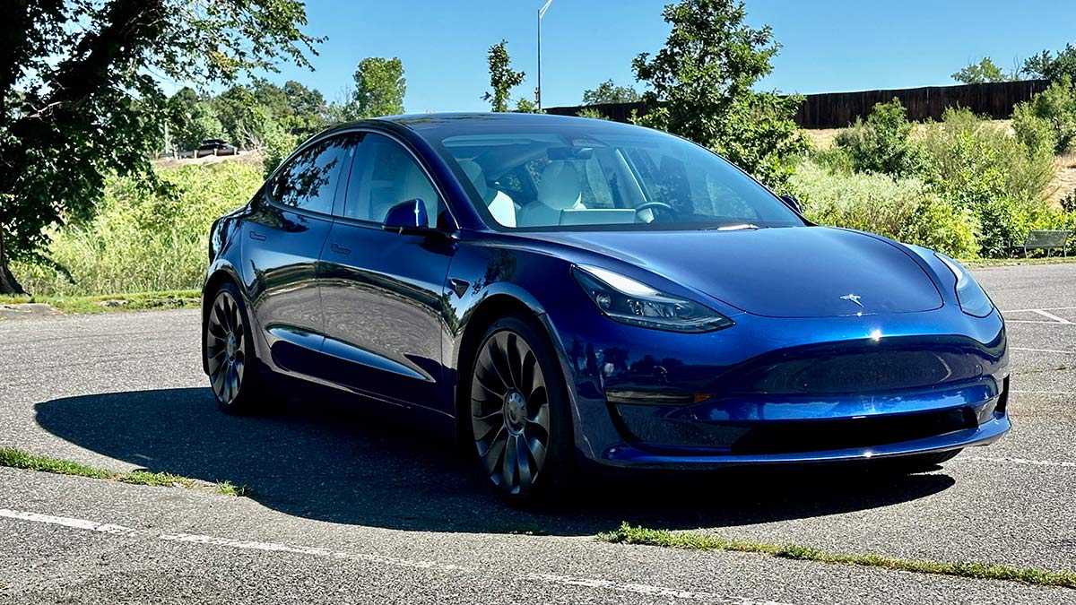 2023 Tesla Model 3 in blue parked outside,